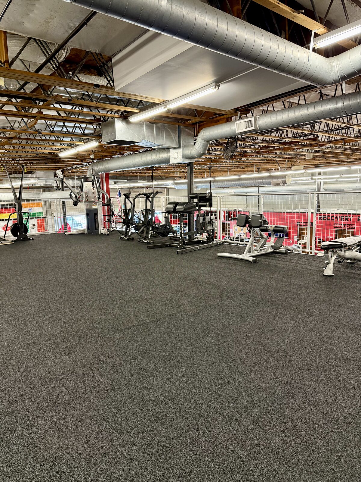 Upper-level training floor with rowers, bikes and adjustable benches